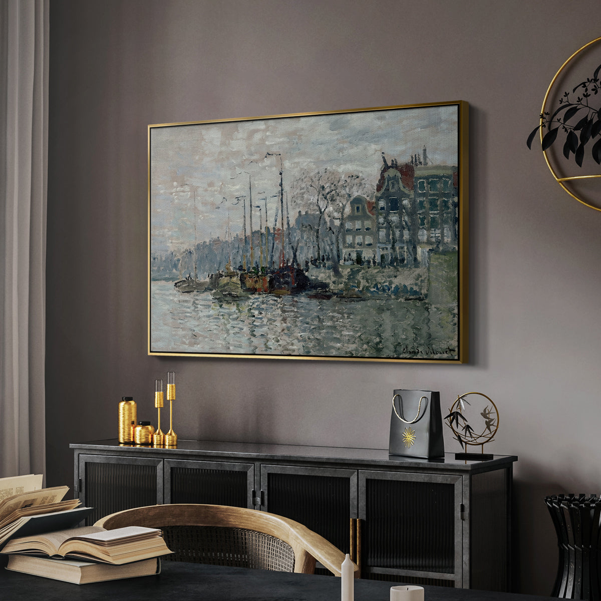 View of the Prins Hendrikkade and Kromme Waal in Amsterdam, 1874 by Claude Monet in a gold floater framed canvas featuring an urban waterway with docked boats and European buildings, displayed above a desk in a dark home office interior.