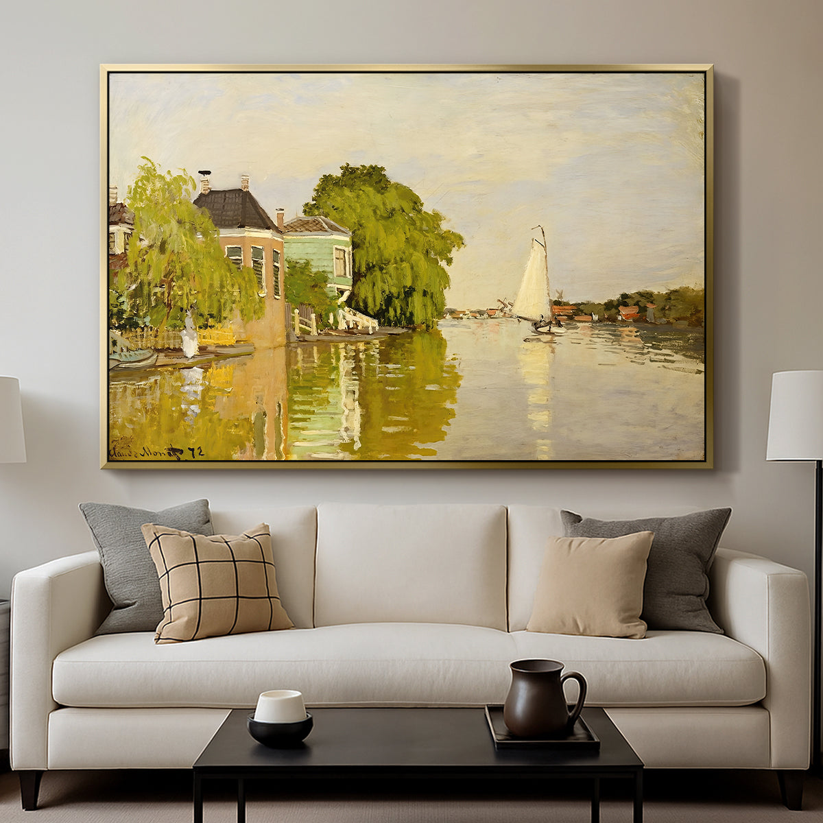 Houses on the Achterzaan, 1871 by Claude Monet displayed in a gold floater framed canvas above a sofa in a clean living room.