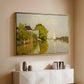 Gold floater framed canvas of Houses on the Achterzaan, 1871 by Claude Monet, featuring riverside homes with trees and mirrored reflections in water above a console cabinet in a minimalist entryway.
