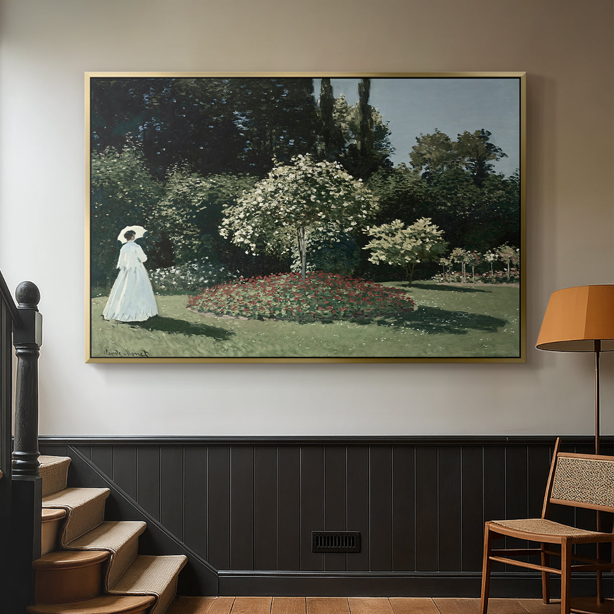 Gold floater framed canvas featuring a tranquil garden portrait with soft natural light, displayed in a hallway near a staircase.