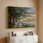 Gold floater framed canvas of On the Bank of the Seine, Bennecourt, 1868 by Claude Monet, featuring a peaceful riverside scene with figures resting in grassy area by water above a console cabinet in a minimalist entryway.