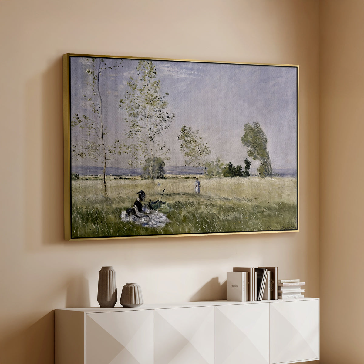 Gold floater framed canvas of Summer (L'ete), 1874 by Claude Monet, featuring an impressionist countryside scene with figure resting in shade above a console cabinet in a minimalist entryway.