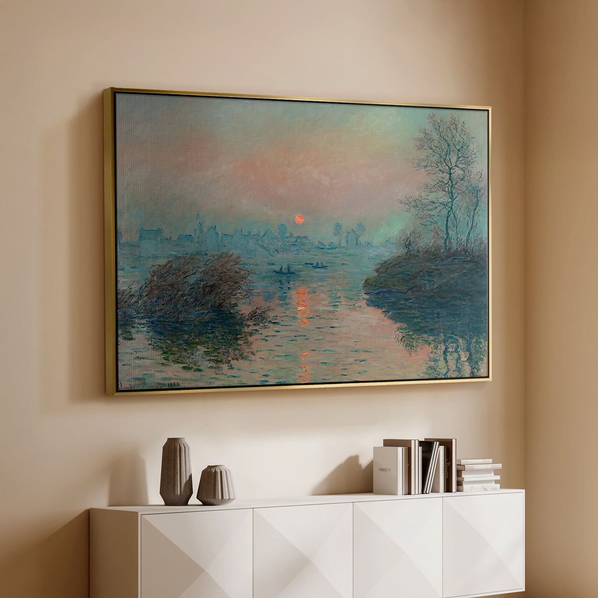 Gold floater framed canvas of Sunset on the Seine at Lavacourt, Winter Effect, 1880 by Claude Monet, featuring a winter scene with warm light reflecting on water at dusk above a console cabinet in a minimalist entryway.
