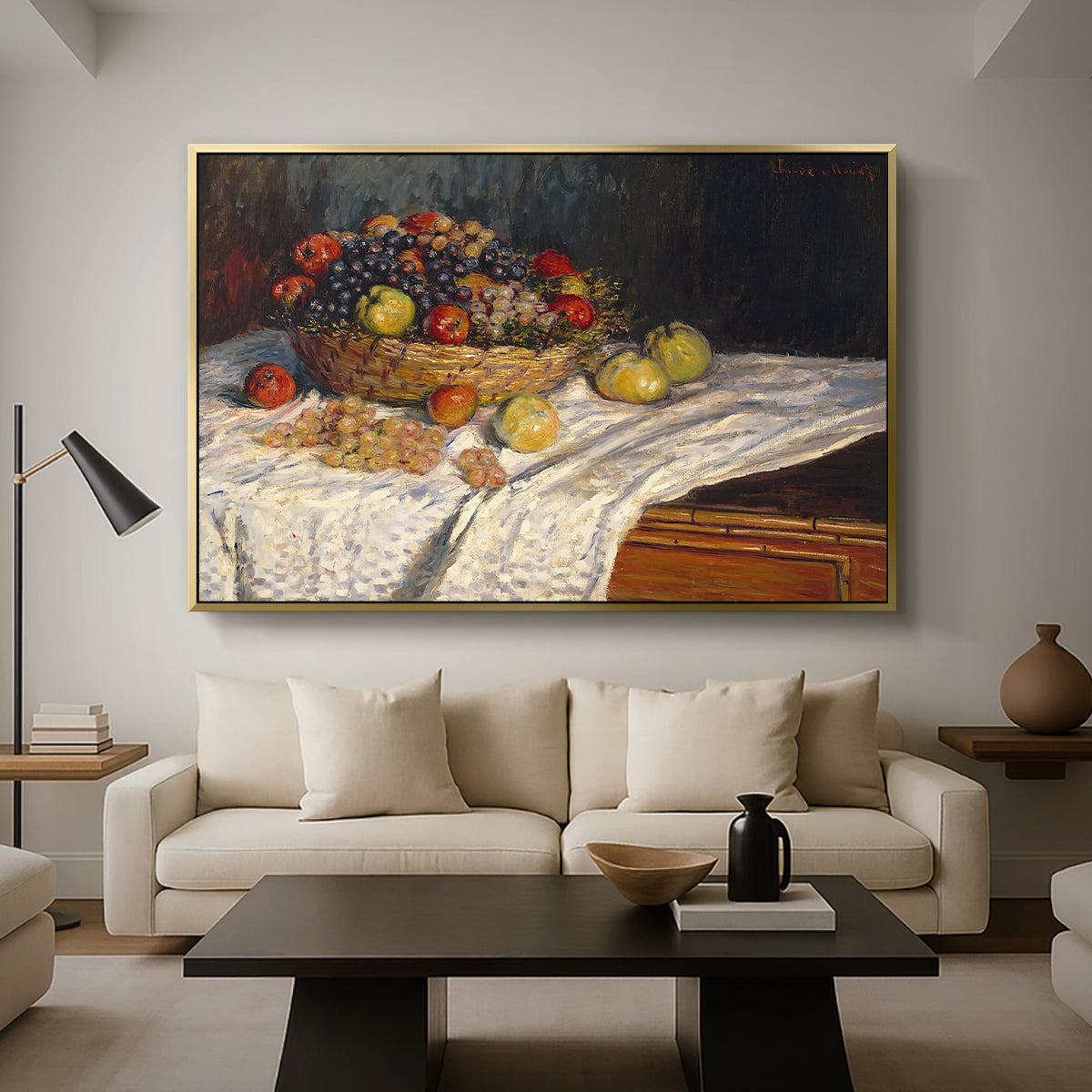 Still Life with Apples and Grapes, 1880 by Claude Monet as a gold floater framed canvas featuring an arrangement of apples and grapes on table with soft natural light, displayed above a sofa in a modern living room.