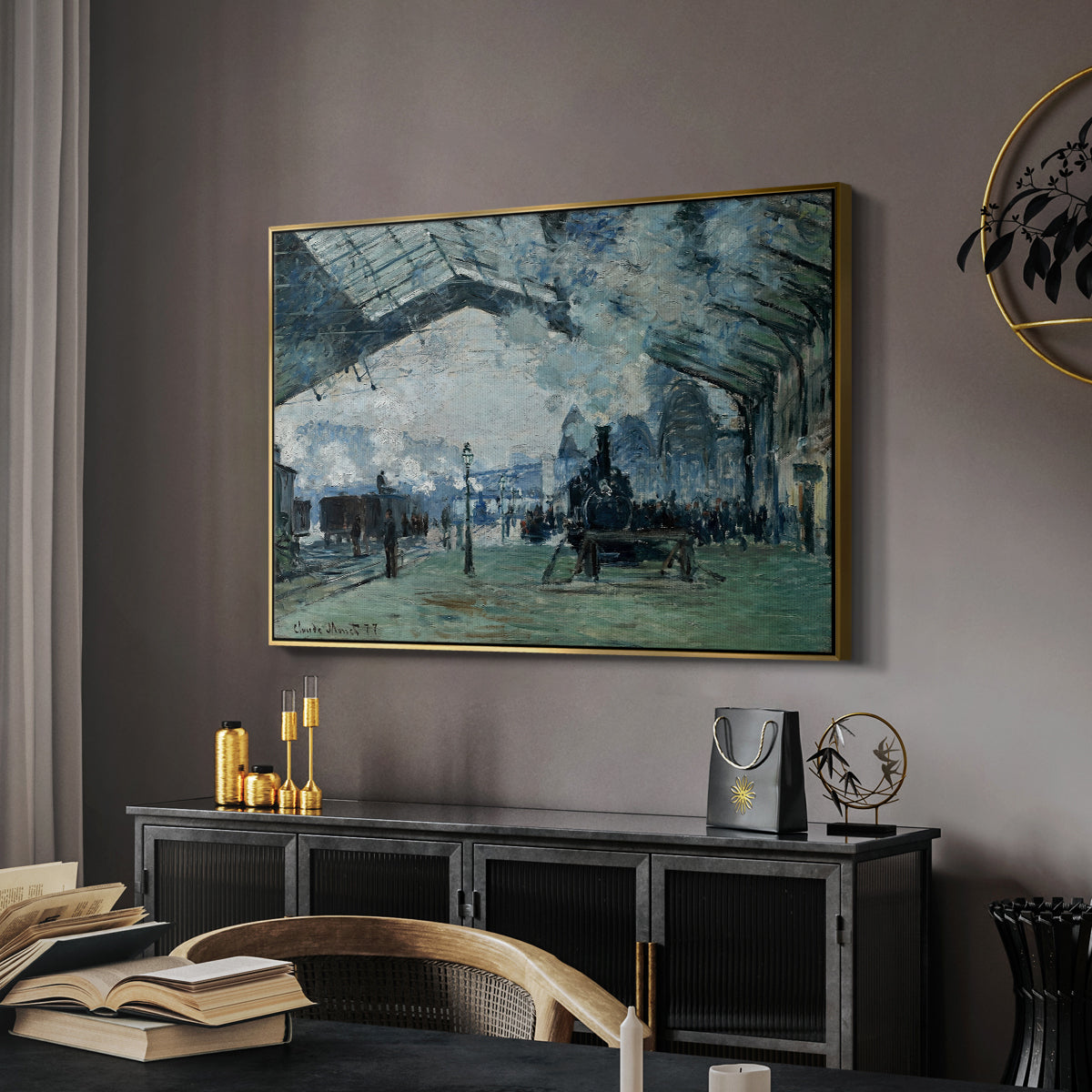 The Saint-Lazare Station, 1877 by Claude Monet in a gold floater framed canvas featuring an interior view of station filled with movement and smoke, displayed above a desk in a dark home office interior.