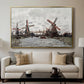 Windmills near Zaandam, 1871 by Claude Monet displayed in a gold floater framed canvas above a sofa in a clean living room.