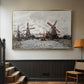 Gold floater framed canvas featuring a landscape featuring windmills and low horizon sky, displayed in a hallway near a staircase.