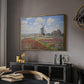 Tulip Fields with the Rijnsburg Windmill, 1886 by Claude Monet in a gold floater framed canvas featuring an impressionist field of blooming tulips under bright sky, displayed above a desk in a dark home office interior.