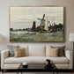 Windmill at Zaandam, 1871 by Claude Monet displayed in a gold floater framed canvas above a sofa in a clean living room.
