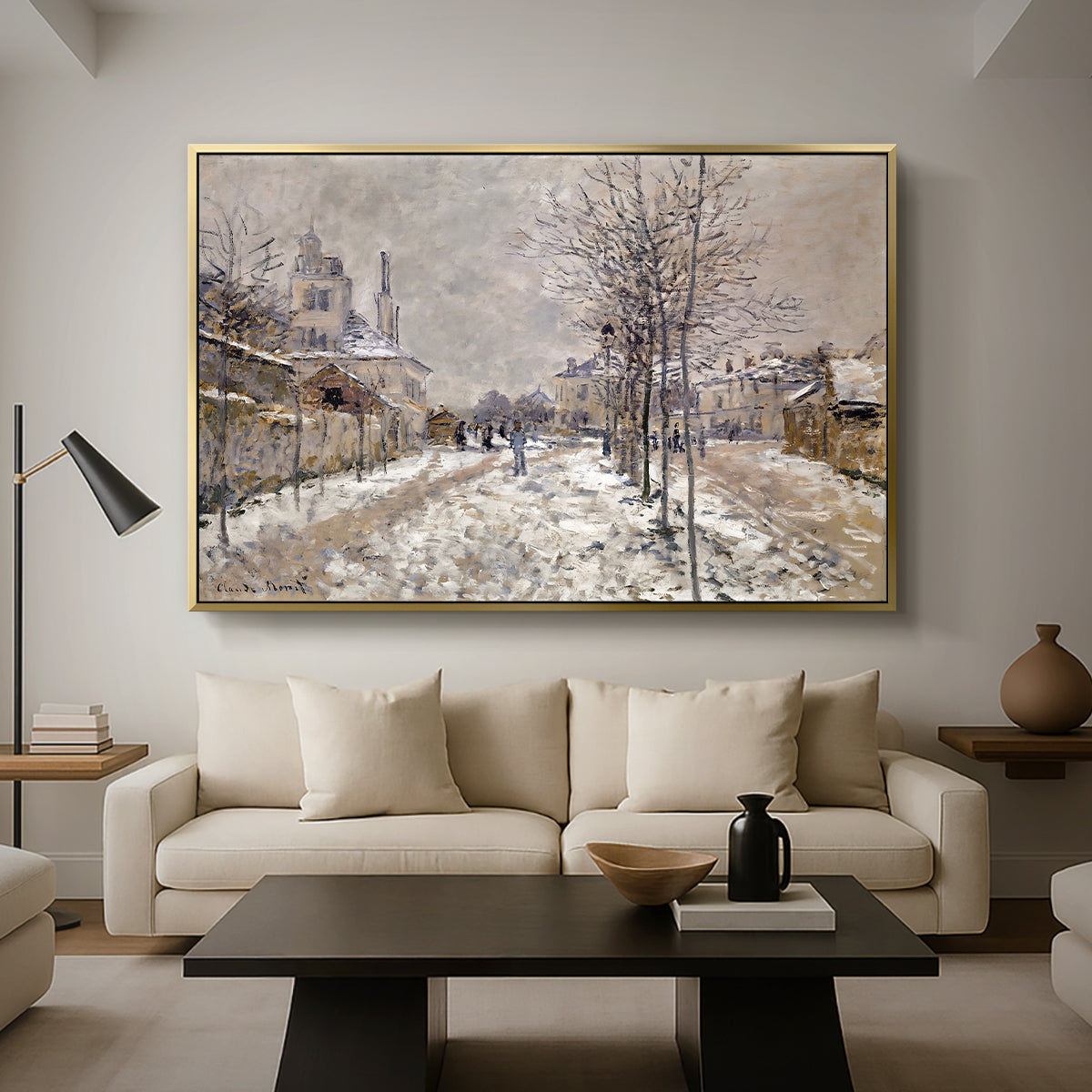 The Boulevard de Pontoise at Argenteuil, Snow Effect, 1875 by Claude Monet as a gold floater framed canvas featuring a snow-covered street lined with trees and buildings under winter sky, displayed above a sofa in a modern living room.