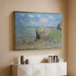 Gold floater framed canvas of The Cliff Walk at Pourville, 1882 by Claude Monet, featuring an impressionist seaside landscape with people strolling above water above a console cabinet in a minimalist entryway.
