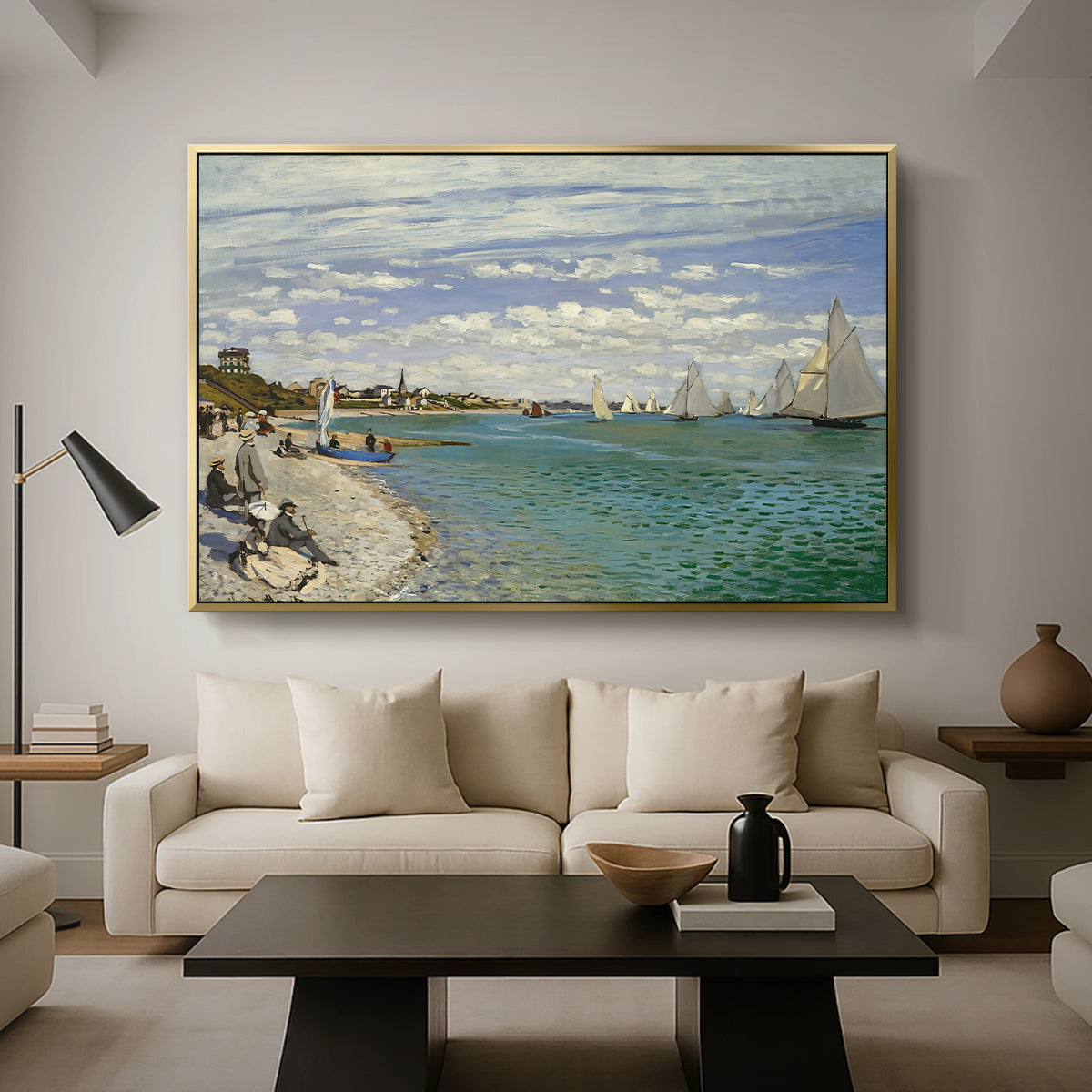 Regatta at Sainte-Adresse, 1867 by Claude Monet as a gold floater framed canvas featuring sailboats gathered near shore with flags and spectators along coastline, displayed above a sofa in a modern living room.