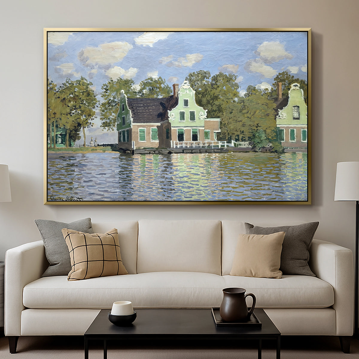 Houses on the Zaan River at Zaandam, 1871 by Claude Monet displayed in a gold floater framed canvas above a sofa in a clean living room.