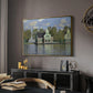 Houses on the Zaan River at Zaandam, 1871 by Claude Monet in a gold floater framed canvas featuring a peaceful canal scene with houses mirrored in water, displayed above a desk in a dark home office interior.