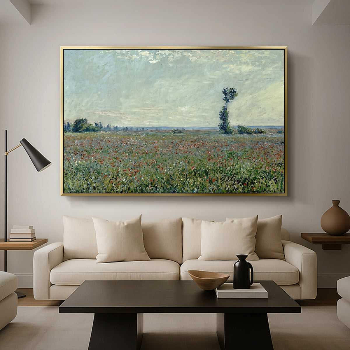Poppy Field, 1881 by Claude Monet as a gold floater framed canvas featuring a wide field of red poppies stretching across countryside under open sky, displayed above a sofa in a modern living room.