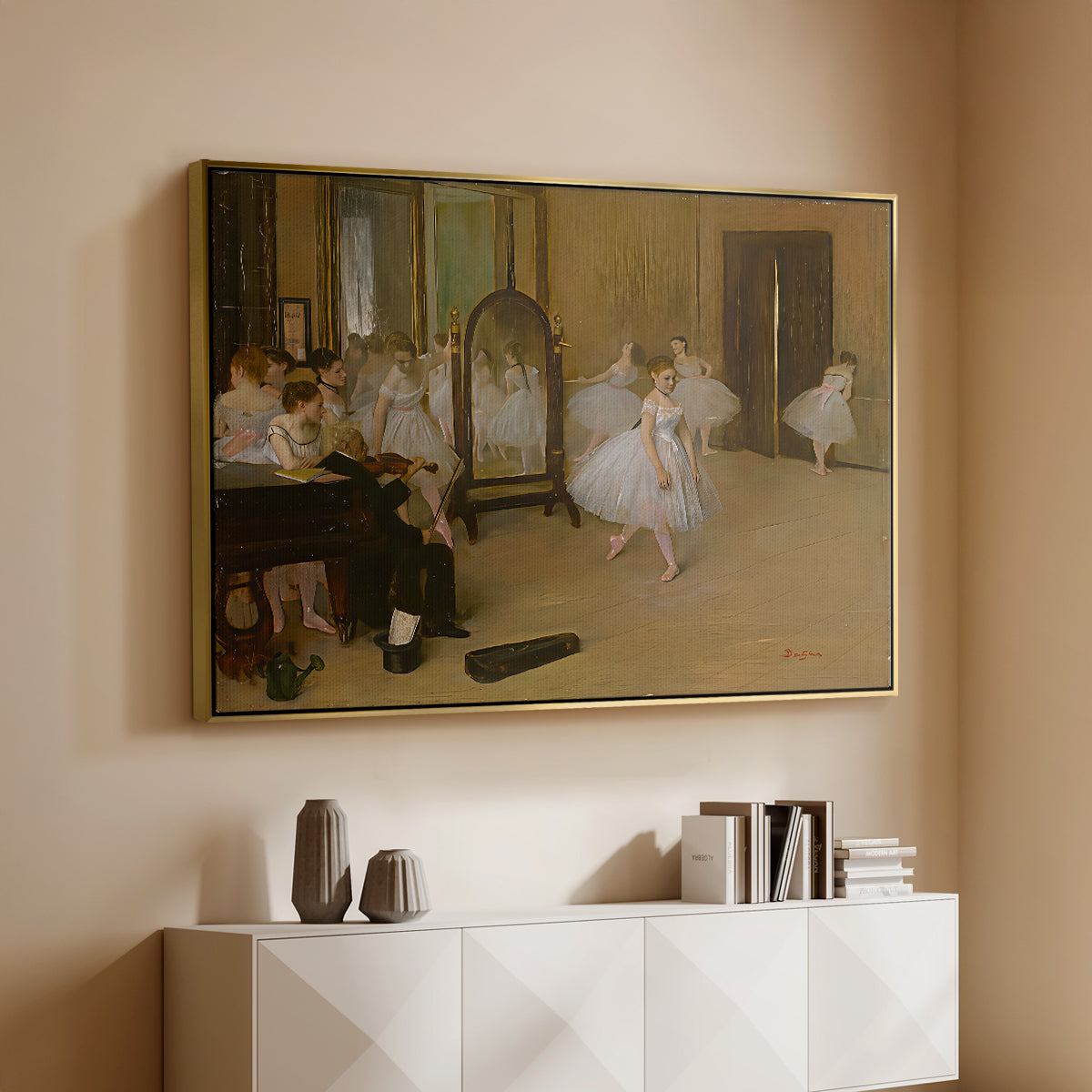 Gold floater framed canvas of The Dancing Class, c. 1870 by Edgar Degas, featuring a rehearsal scene with ballerinas in tutus arranged in studio above a console cabinet in a minimalist entryway.