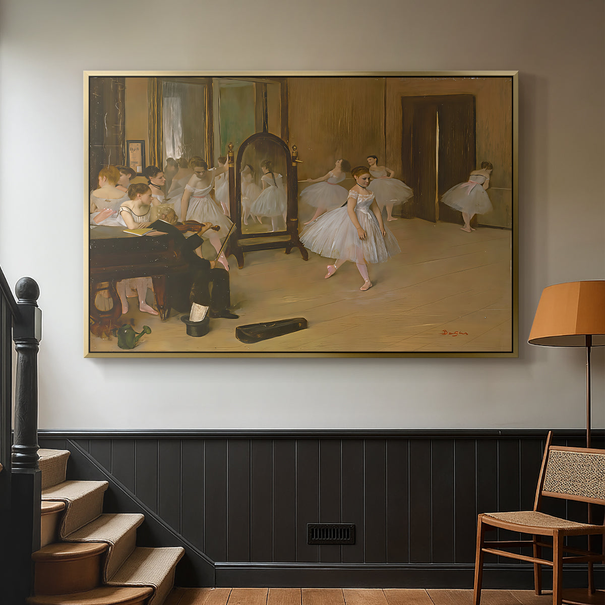 Gold floater framed canvas featuring a group of dancers mid-practice with teacher overseeing, displayed in a hallway near a staircase.