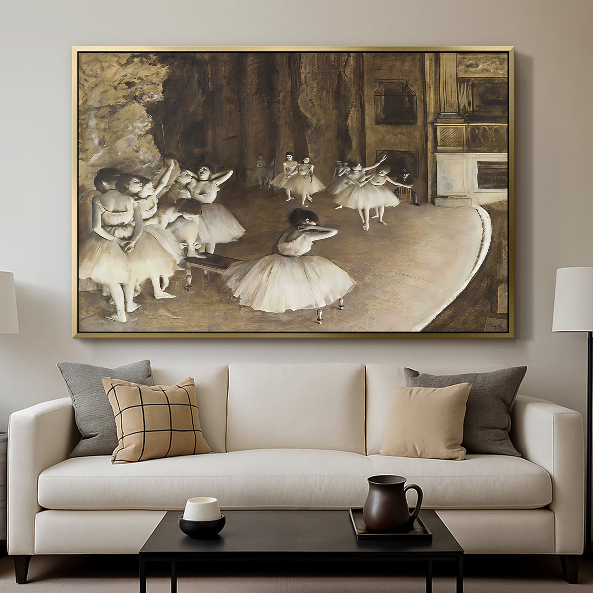 The Rehearsal of the Ballet Onstage, 1874 by Edgar Degas displayed in a gold floater framed canvas above a sofa in a clean living room.