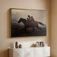 Gold floater framed canvas of A Ride for Liberty – The Fugitive Slaves, c. 1862 by Eastman Johnson, featuring a dramatic scene of enslaved people fleeing on horseback in darkness above a console cabinet in a minimalist entryway.