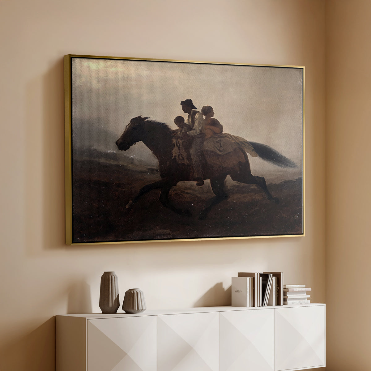 Gold floater framed canvas of A Ride for Liberty – The Fugitive Slaves, c. 1862 by Eastman Johnson, featuring a dramatic scene of enslaved people fleeing on horseback in darkness above a console cabinet in a minimalist entryway.