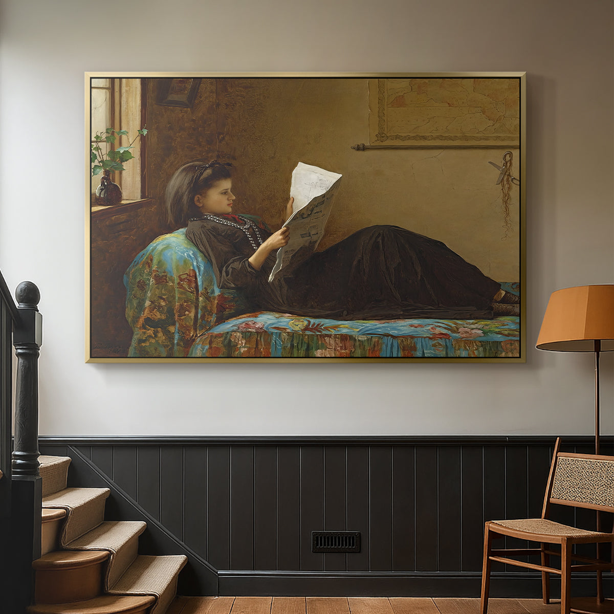 Gold floater framed canvas featuring a casual gathering around newspaper in rustic room, displayed in a hallway near a staircase.