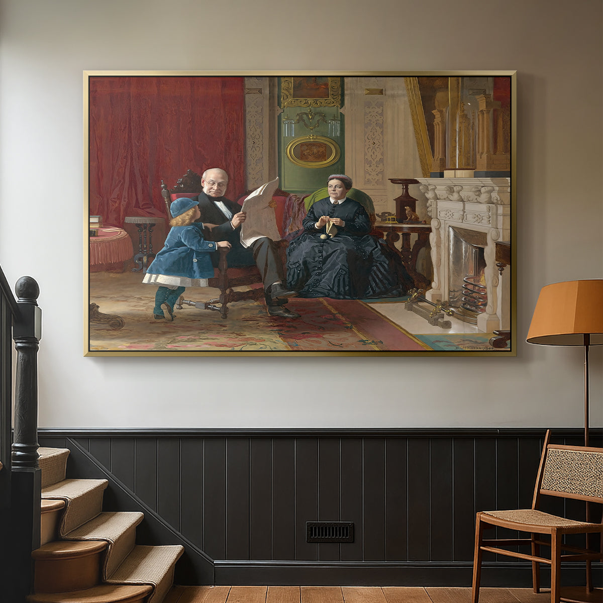 Gold floater framed canvas featuring a family group portrait with warm interior tones, displayed in a hallway near a staircase.