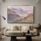 Odenwinklkees with the Johannisberg, 1902 by Edward Theodore Compton as a gold floater framed canvas featuring an alpine glacier landscape with rugged peaks and snow-covered terrain, displayed above a sofa in a modern living room.