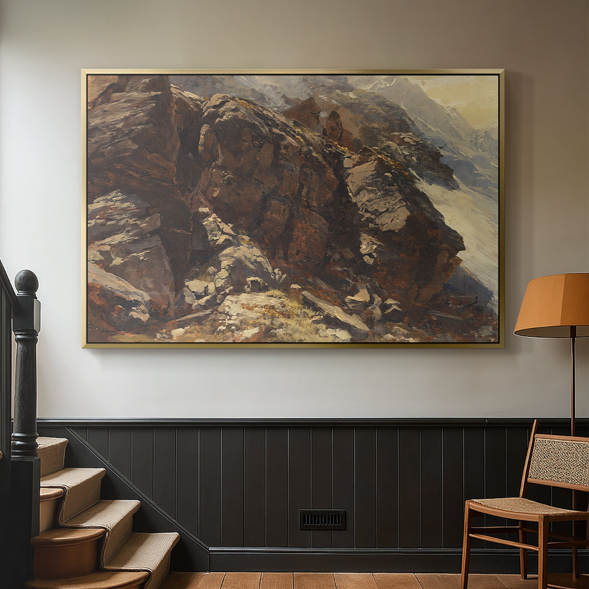 Gold floater framed canvas featuring a realistic depiction of mountainous terrain under open sky, displayed in a hallway near a staircase.