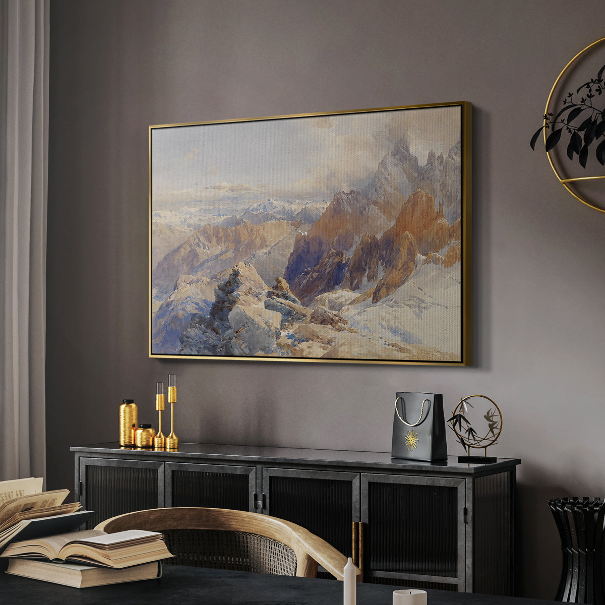 Col du Géant, 1903 by Edward Theodore Compton in a gold floater framed canvas featuring a panoramic alpine view with snow and rocky cliffs, displayed above a desk in a dark home office interior.
