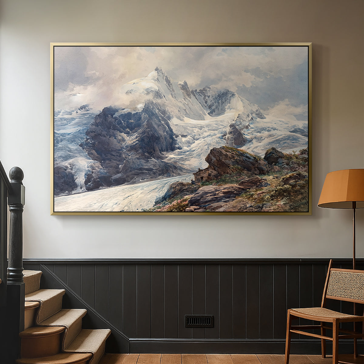 Gold floater framed canvas featuring an alpine peak dominating surrounding terrain, displayed in a hallway near a staircase.