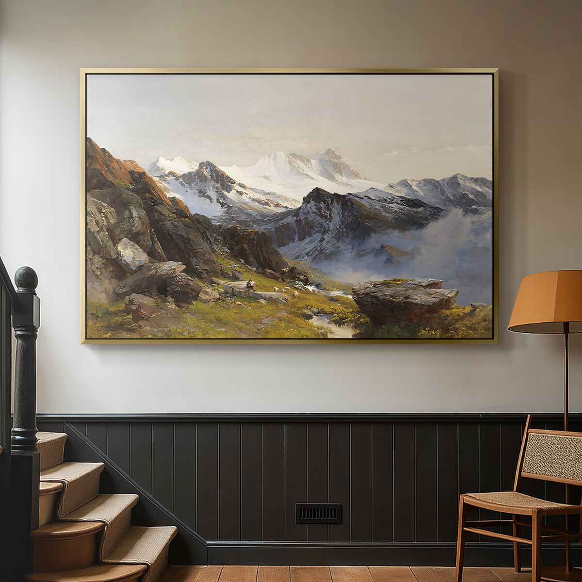 Gold floater framed canvas featuring a scenic mountain view with dramatic elevation and depth, displayed in a hallway near a staircase.