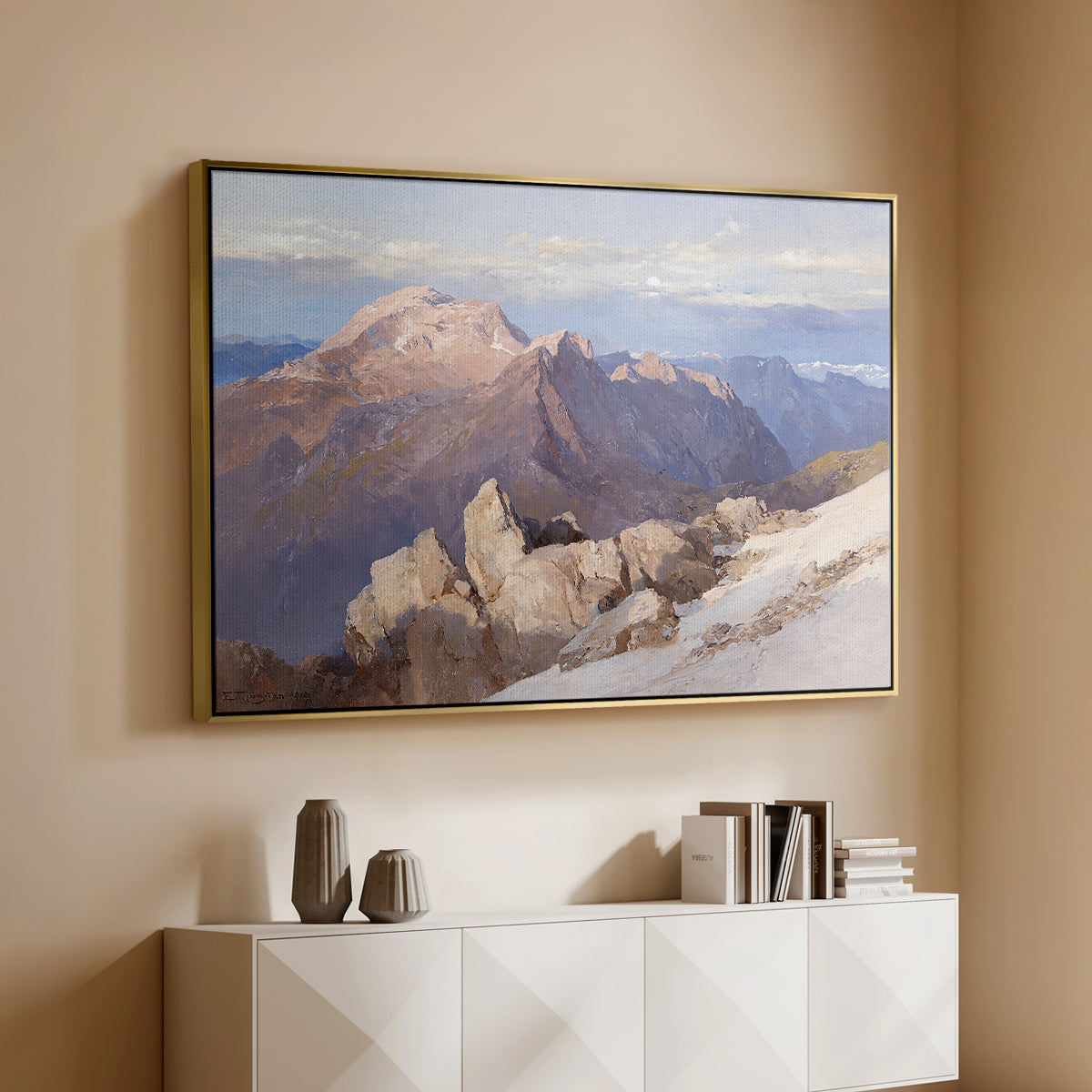 Gold floater framed canvas of Hoher Göll from Watzmann-Hocheck, 1919 by Edward Theodore Compton, featuring an alpine panorama showing layered peaks and valleys above a console cabinet in a minimalist entryway.