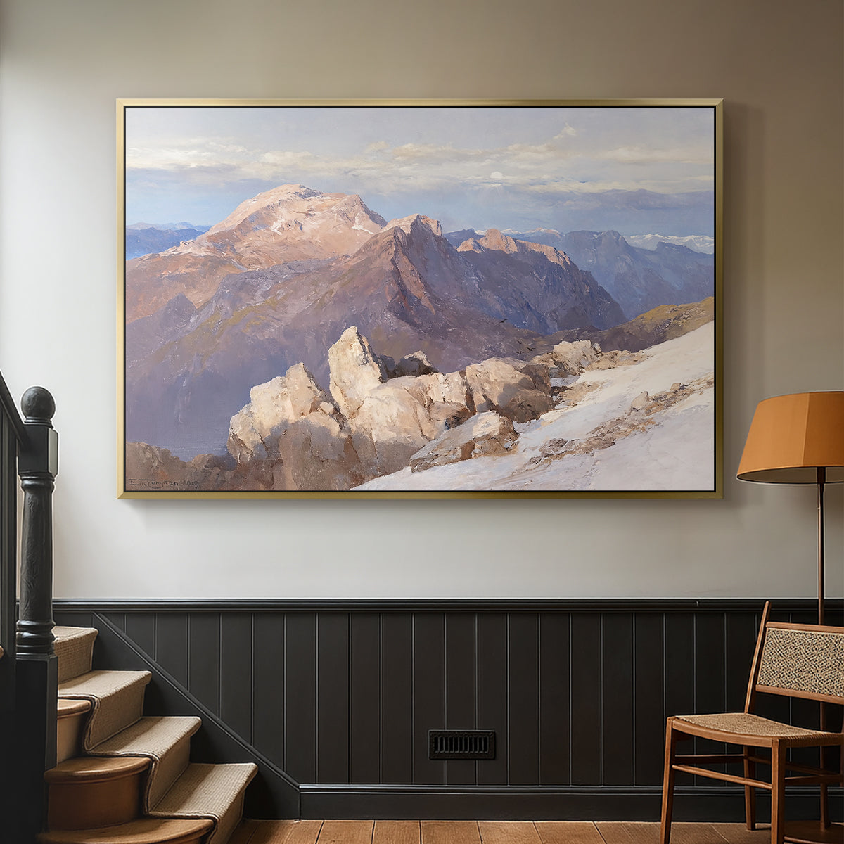 Gold floater framed canvas featuring an expansive mountainous landscape with natural depth, displayed in a hallway near a staircase.