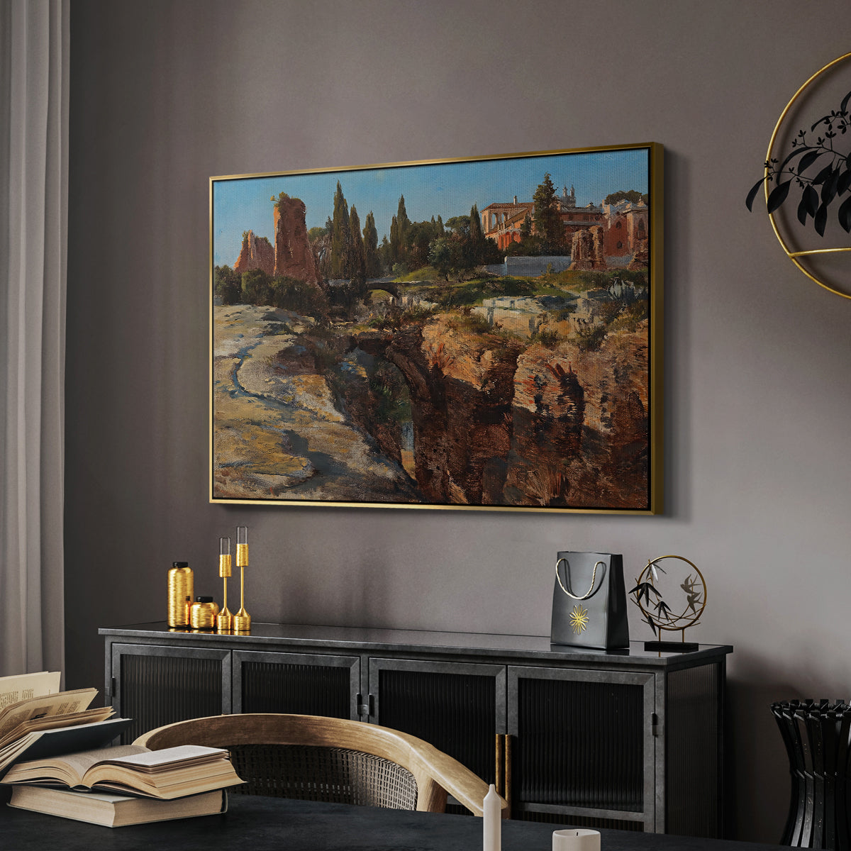 Palatine in Rome, c. 1921 by Edward Theodore Compton in a gold floater framed canvas featuring a cityscape with classical ruins and surrounding terrain, displayed above a desk in a dark home office interior.