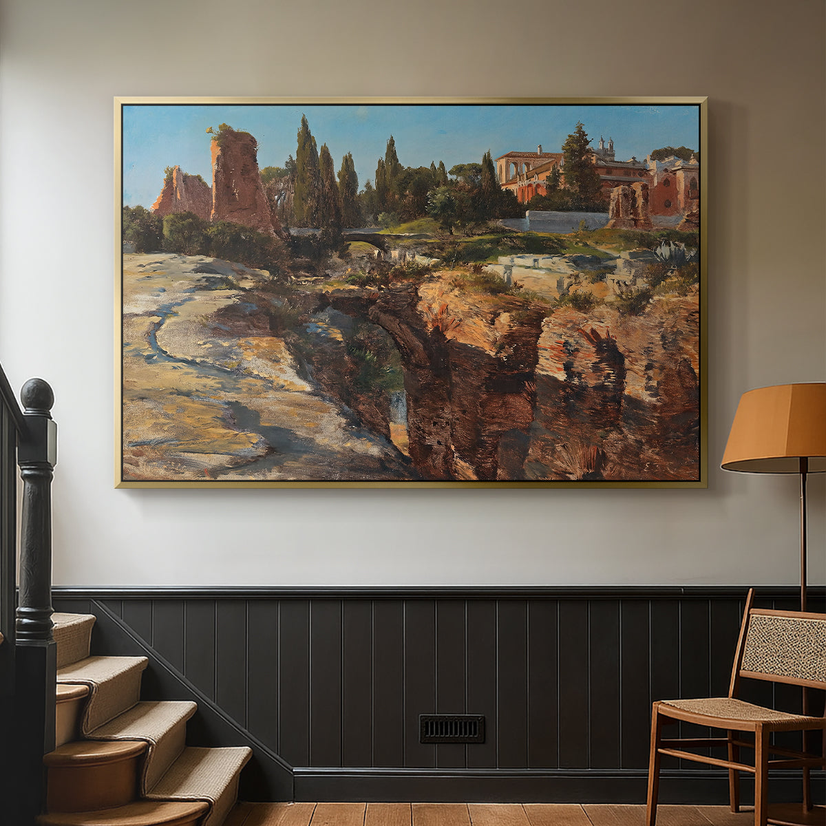 Gold floater framed canvas featuring a detailed depiction of historic Roman architecture, displayed in a hallway near a staircase.