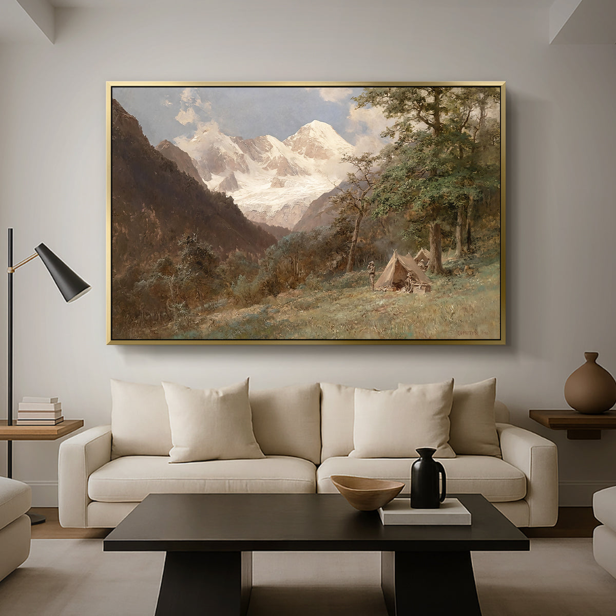 Landscape in the Caucasus, c. 1921 by Edward Theodore Compton as a gold floater framed canvas featuring a mountainous landscape with rugged terrain and distant peaks, displayed above a sofa in a modern living room.