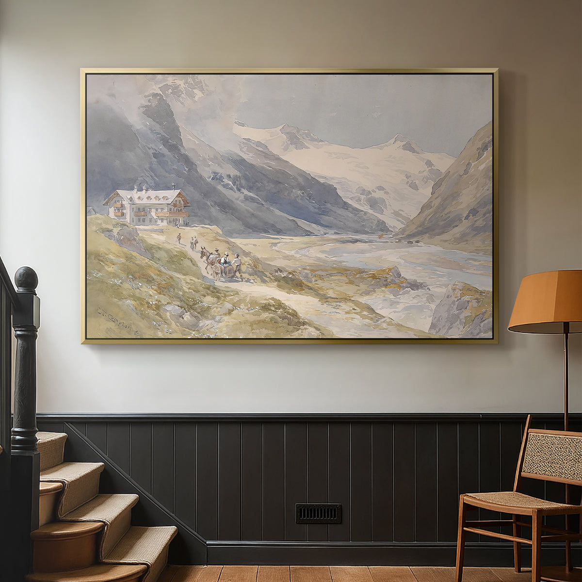 Gold floater framed canvas featuring a natural landscape with human presence among mountains, displayed in a hallway near a staircase.