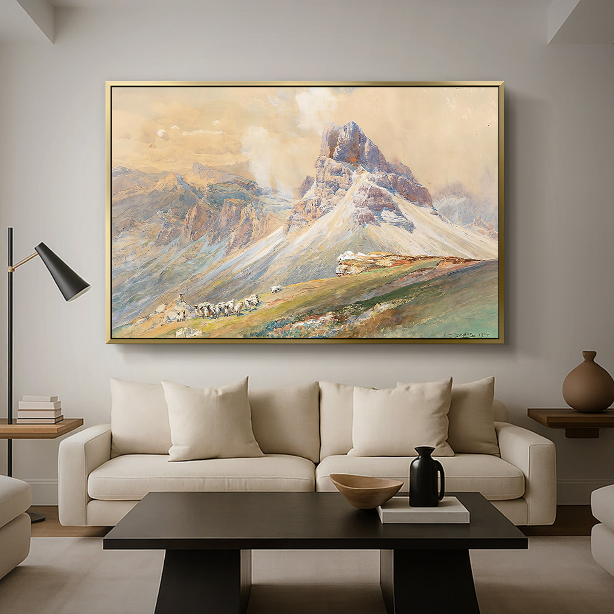 From the Dolomites, 1904 by Edward Theodore Compton as a gold floater framed canvas featuring dramatic Dolomite mountain peaks rising above rugged terrain, displayed above a sofa in a modern living room.