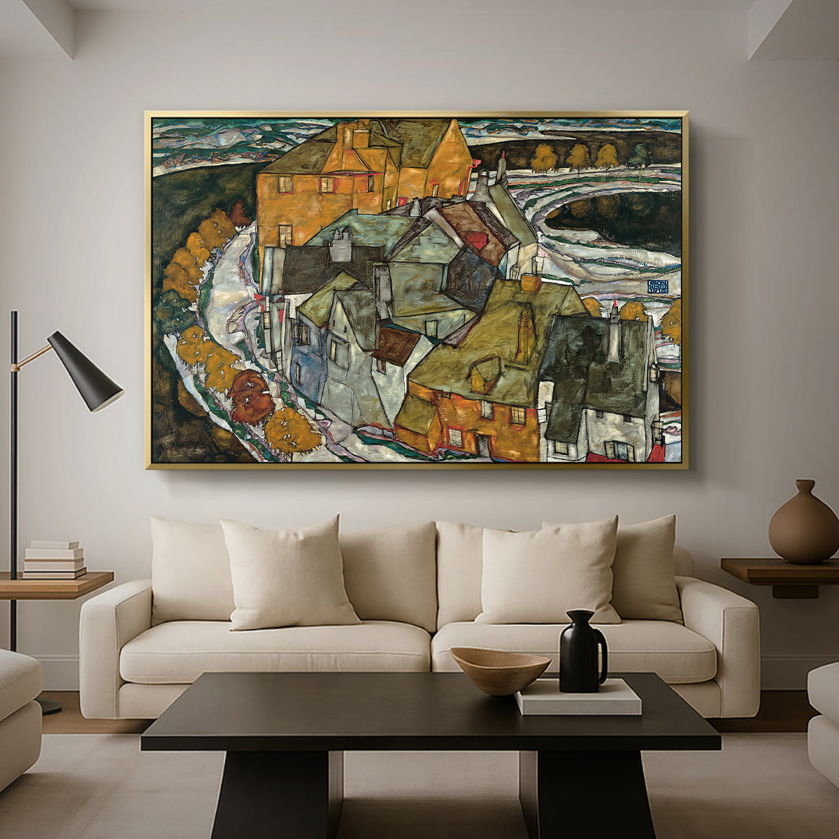 Crescent of Houses II (Island Town), 1915 by Egon Schiele as a gold floater framed canvas featuring a curved row of colorful houses forming crescent shape along water, displayed above a sofa in a modern living room.