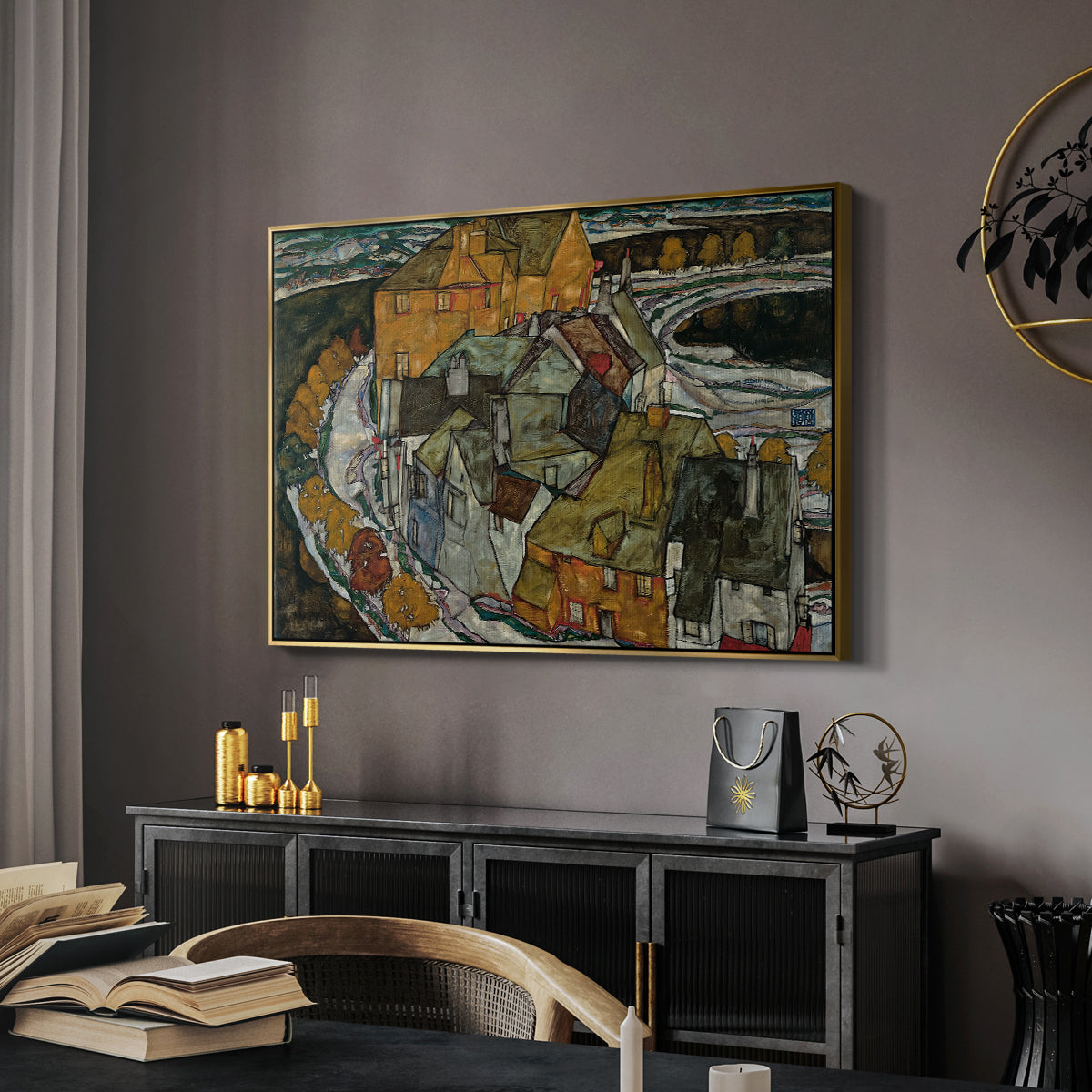 Crescent of Houses II (Island Town), 1915 by Egon Schiele in a gold floater framed canvas featuring an expressionist depiction of island town with geometric forms, displayed above a desk in a dark home office interior.