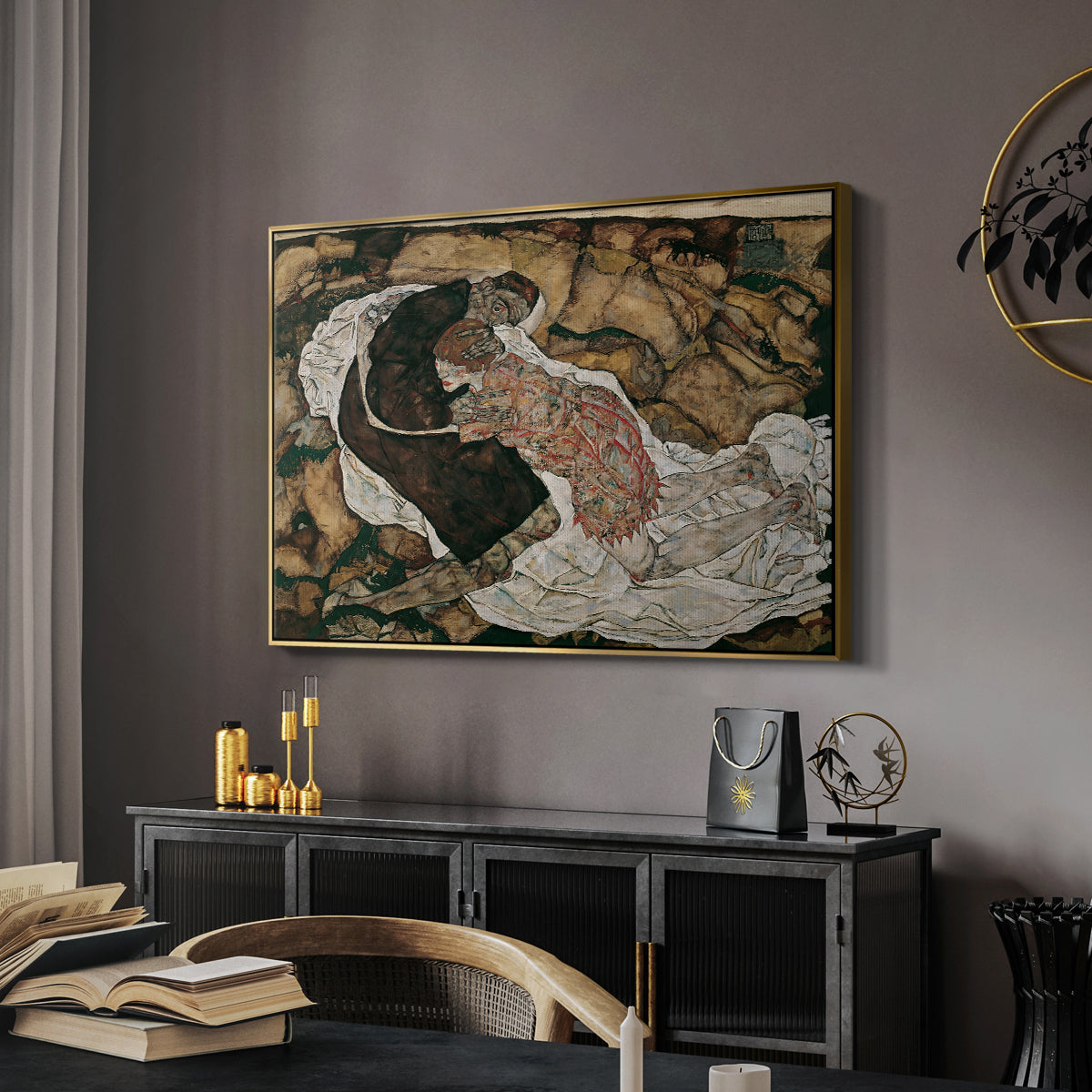 Death and the Maiden, 1915 by Egon Schiele in a gold floater framed canvas featuring an expressionist painting of human figures in dramatic pose, displayed above a desk in a dark home office interior.