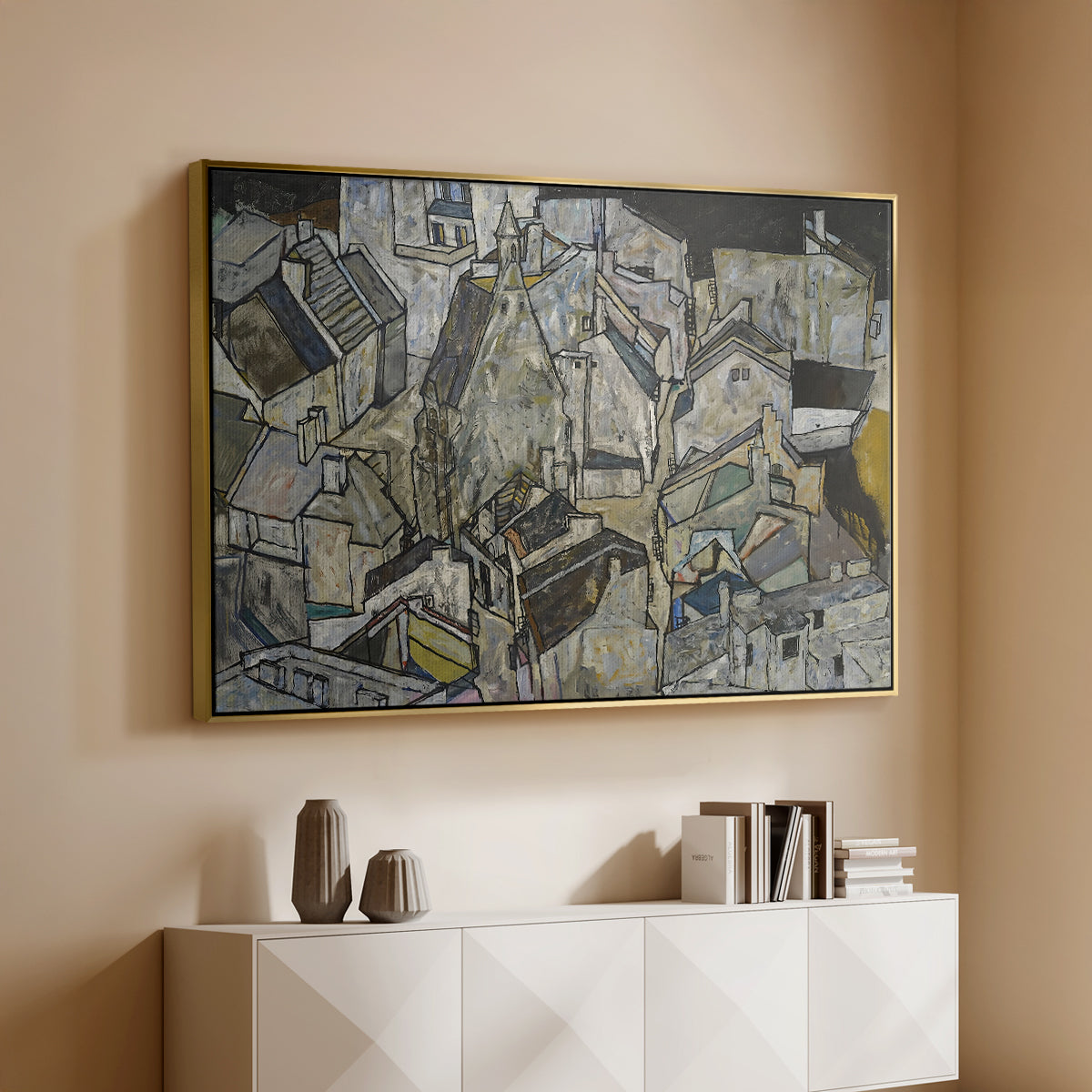 Gold floater framed canvas of Mödling II, 1918 by Egon Schiele, featuring an expressionist cityscape with tightly packed buildings and bold lines above a console cabinet in a minimalist entryway.