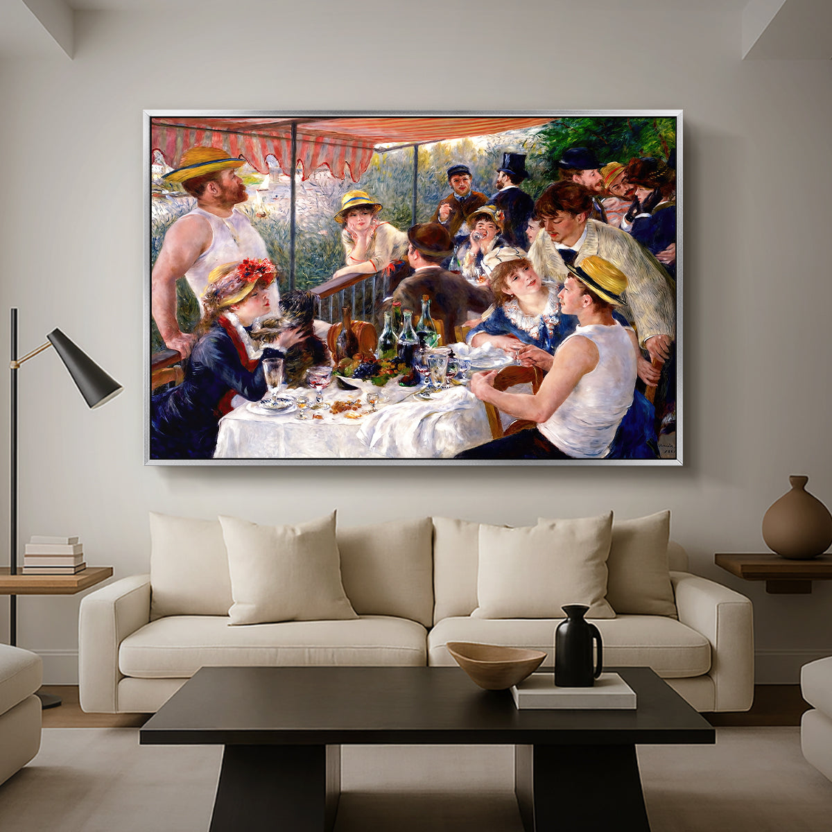 Luncheon of the Boating Party (Le Déjeuner des canotiers), 1880-1881 by Pierre-Auguste Renoir as a silver floater framed canvas featuring a group of elegantly dressed people dining together on a sunlit balcony overlooking the river, displayed above a sofa in a modern living room.