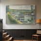 Silver floater framed canvas featuring an everyday life scene with boat and figures along river edge, displayed in a hallway near a staircase.
