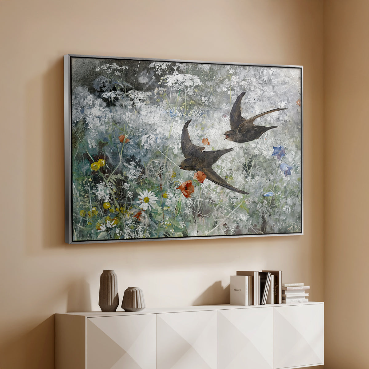 Silver floater framed canvas of Common Swifts, 1886 by Bruno Liljefors, featuring swifts gliding midair with wings spread against soft sky above a console cabinet in a minimalist entryway.