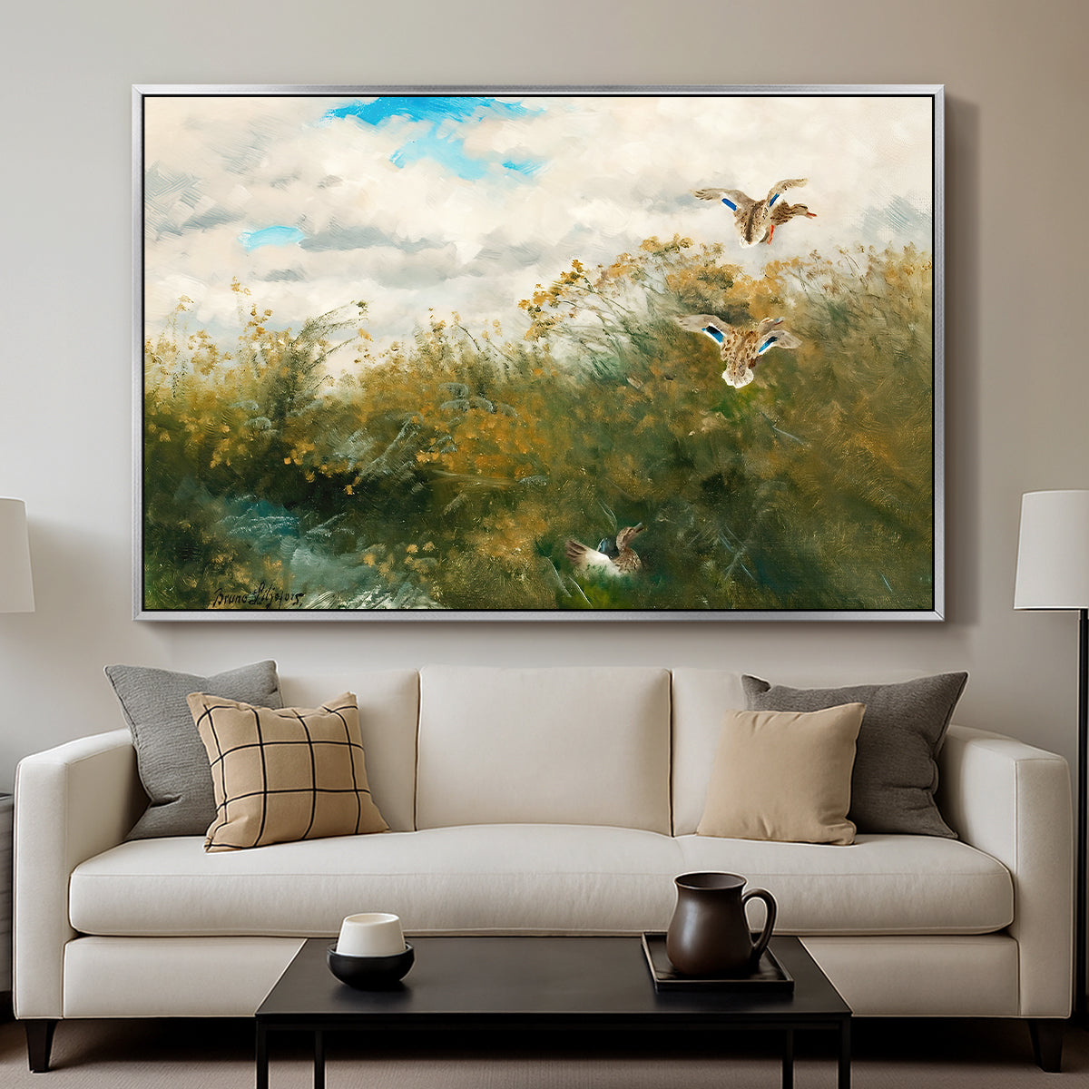 Wild Ducks (Grasänder), 1890 by Bruno Liljefors displayed in a silver floater framed canvas above a sofa in a clean living room.