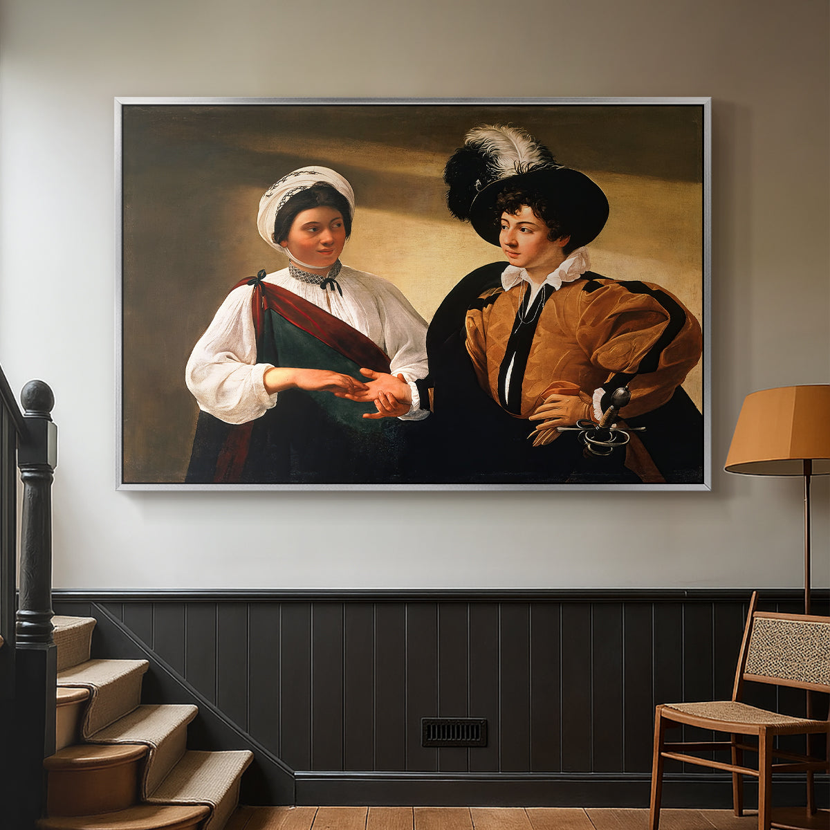Silver floater framed canvas featuring two figures engaged in fortune telling with hidden deception, displayed in a hallway near a staircase.