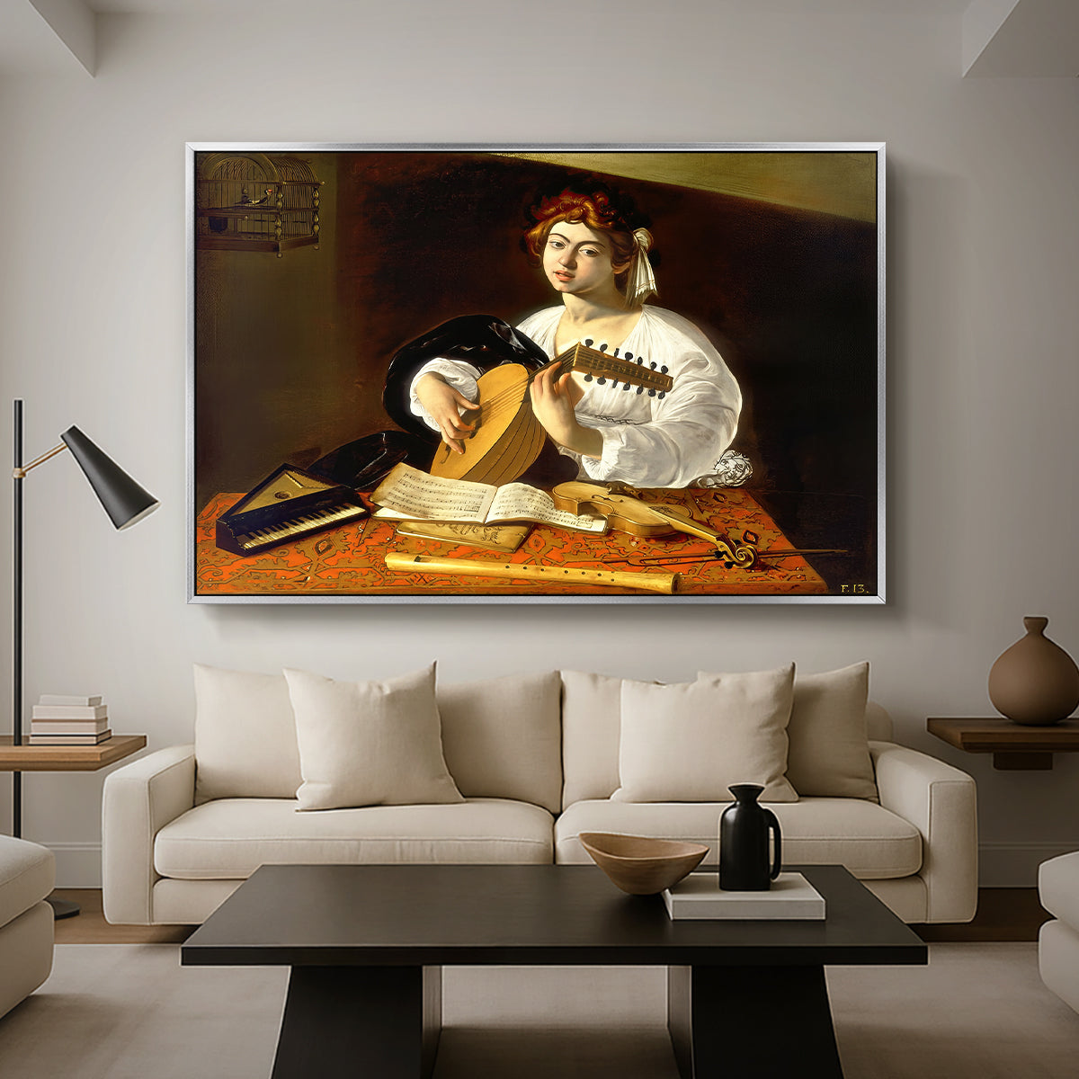 The Lute Player (Wildenstein Version), c. 1596 by Caravaggio as a silver floater framed canvas featuring a young man playing lute surrounded by sheet music and still life objects, displayed above a sofa in a modern living room.