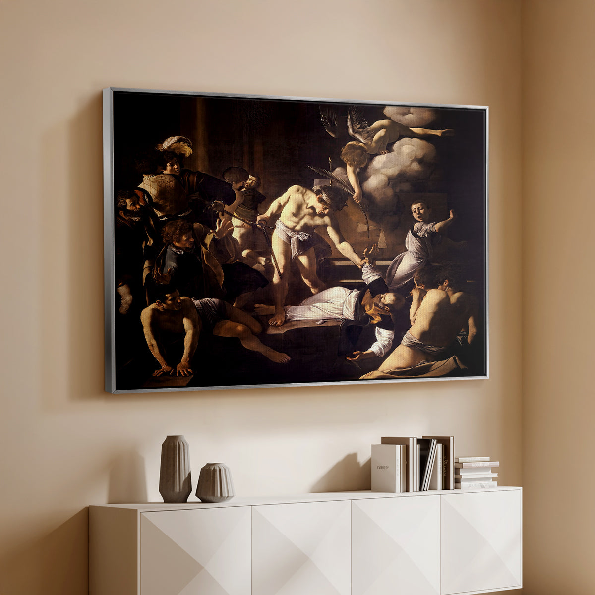 Silver floater framed canvas of The Martyrdom of Saint Matthew, 1599-1600 by Caravaggio, featuring a dramatic moment of martyrdom with figures reacting in panic above a console cabinet in a minimalist entryway.