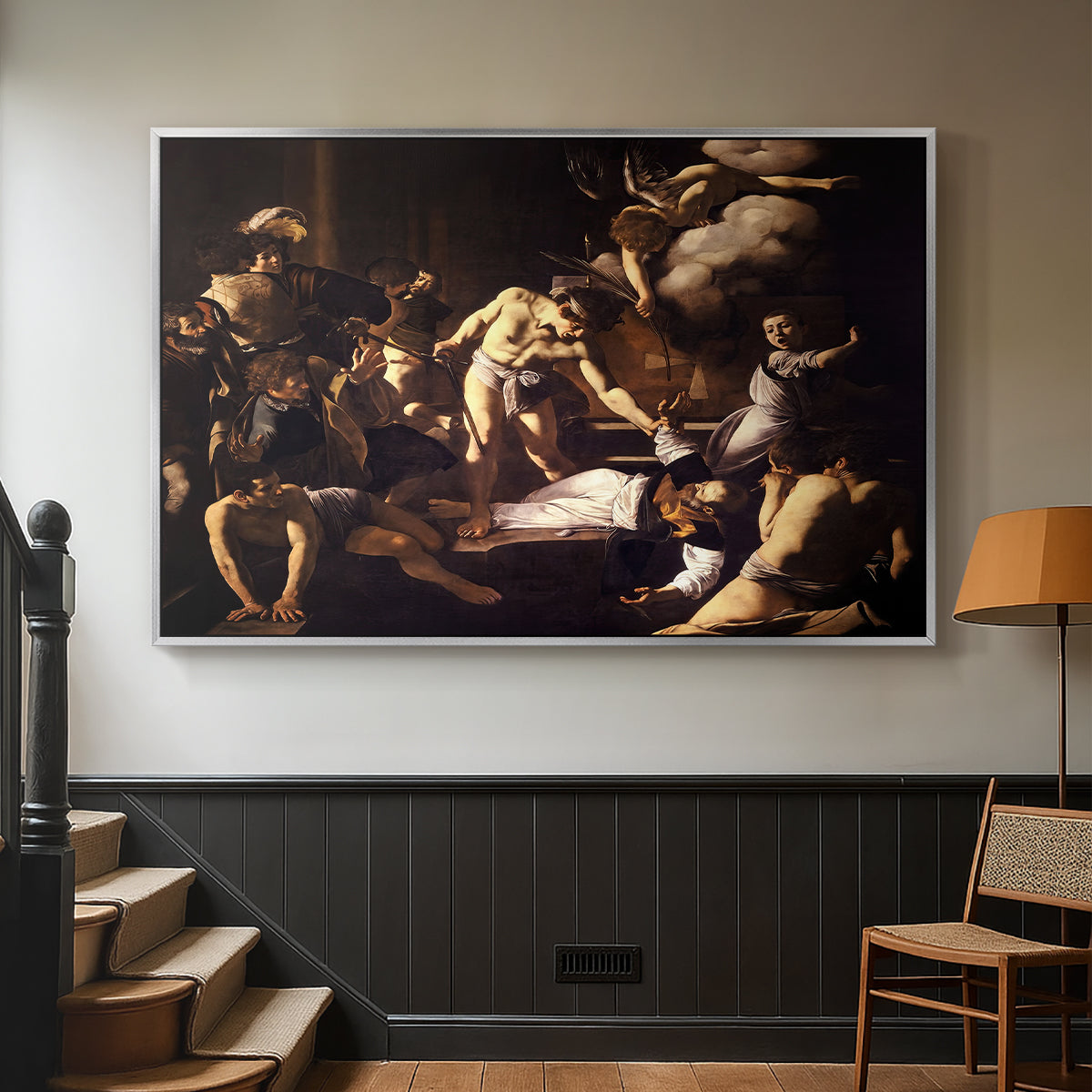 Silver floater framed canvas featuring a Baroque composition of movement and emotion during martyrdom, displayed in a hallway near a staircase.